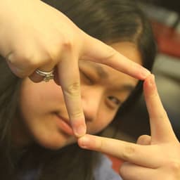 a person forms a diamond with their hands